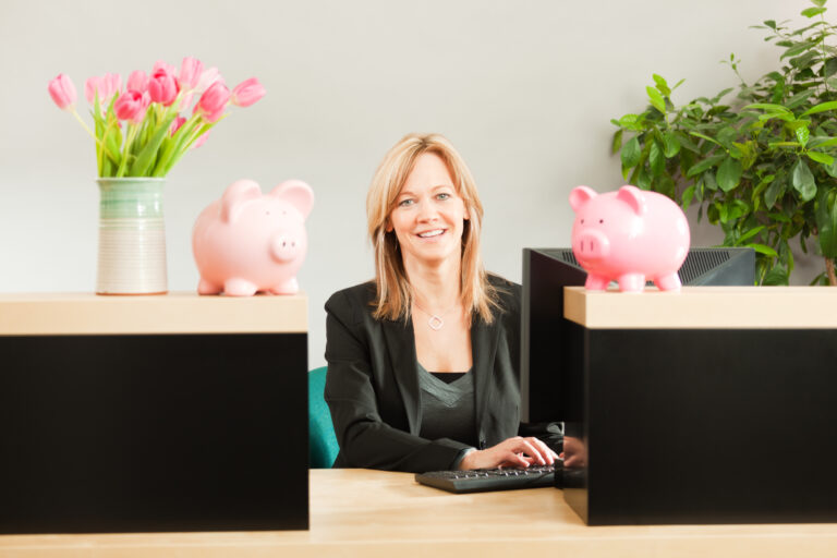 Friendly Woman Banker Working In Retail Banking Teller Window Hz