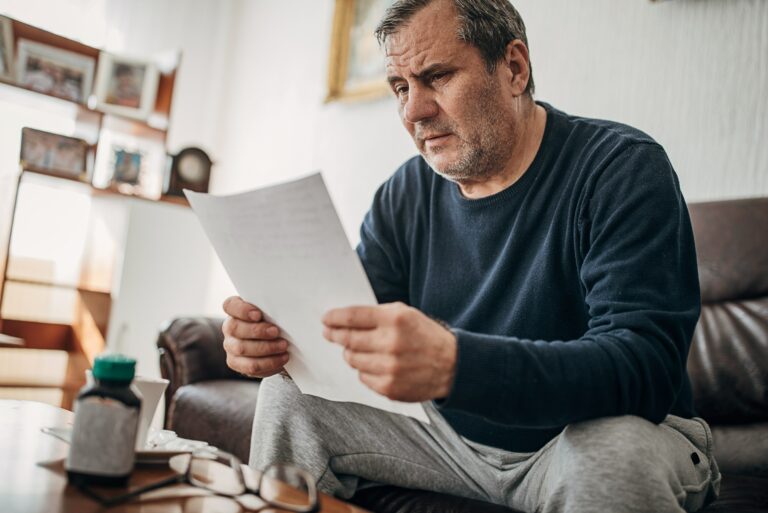 Concerned Man Reads Papers