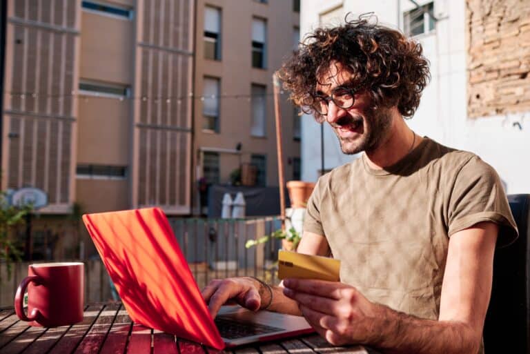 Happy Man Using Credit Card