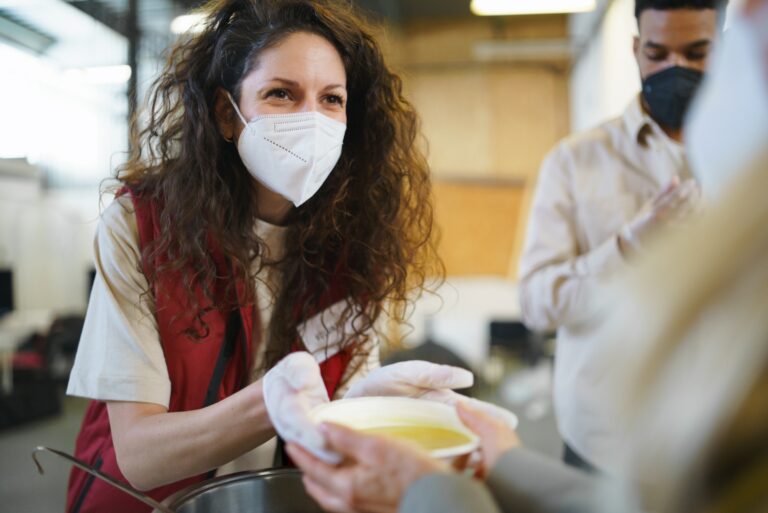 Woman Handing Soup Bowl