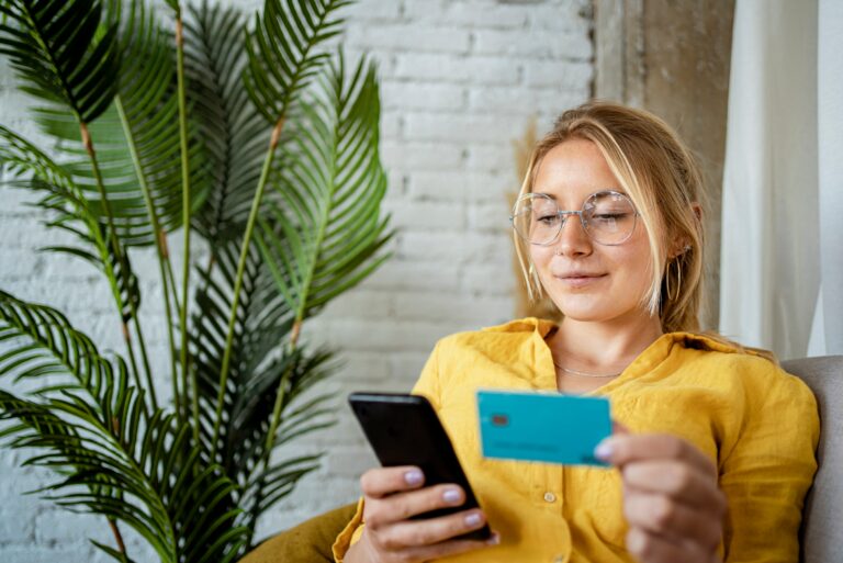 Woman Holding Phone And Debit Card