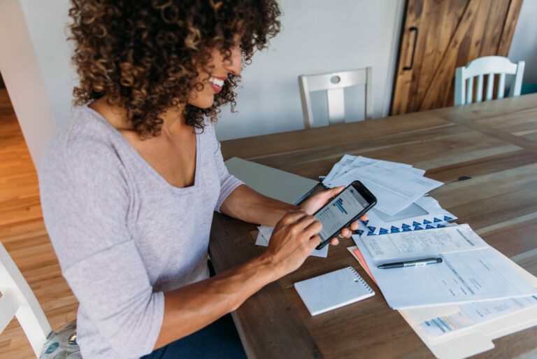 Woman Smartphone Papers Table